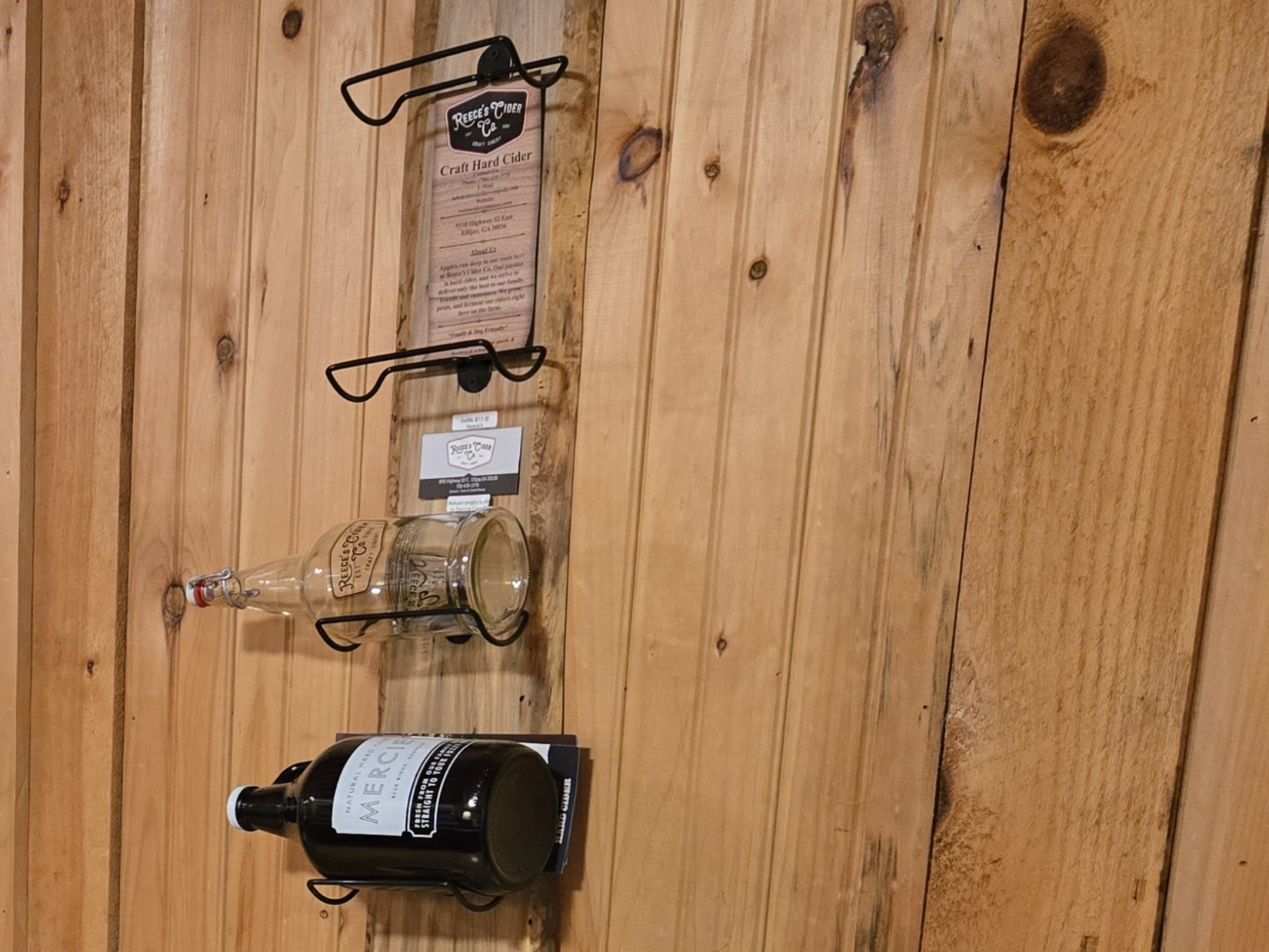 Reece's Cider and Mercier cider bottles on the cabin wall rack at Headwaters in Suches GA